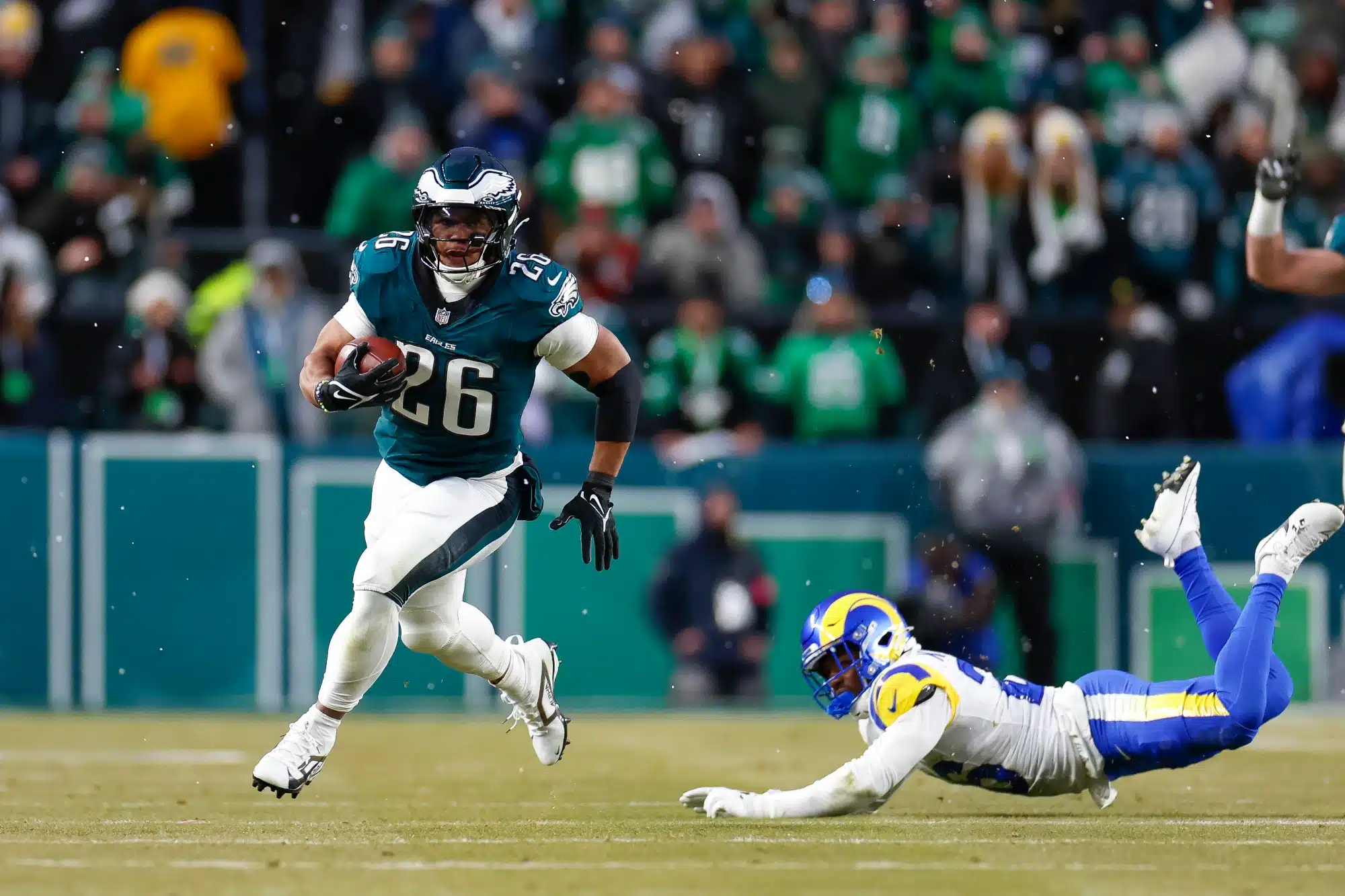 Saquon Barkley #26 of the Philadelphia Eagles runs for a touchdown in the first quarter during the NFC Divisional Playoff game against the Los Angeles Rams at Lincoln Financial Field on January 19, 2025 in Philadelphia, Pennsylvania.