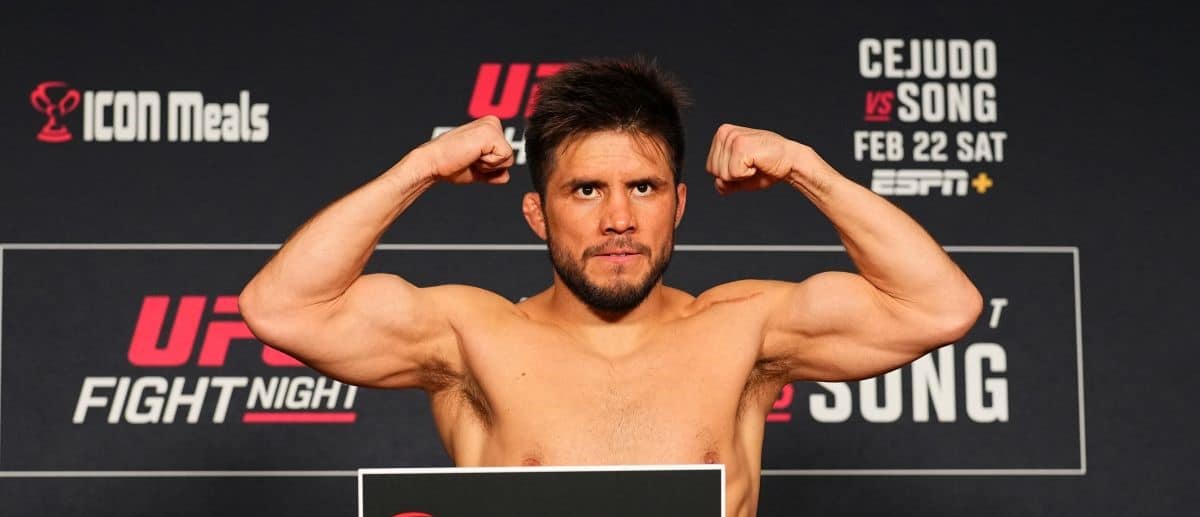 Henry Cejudo poses on the scale during the UFC Fight Night official weigh-in at the Hyatt at Olive 8 on February 21, 2025 in Seattle, Washington.