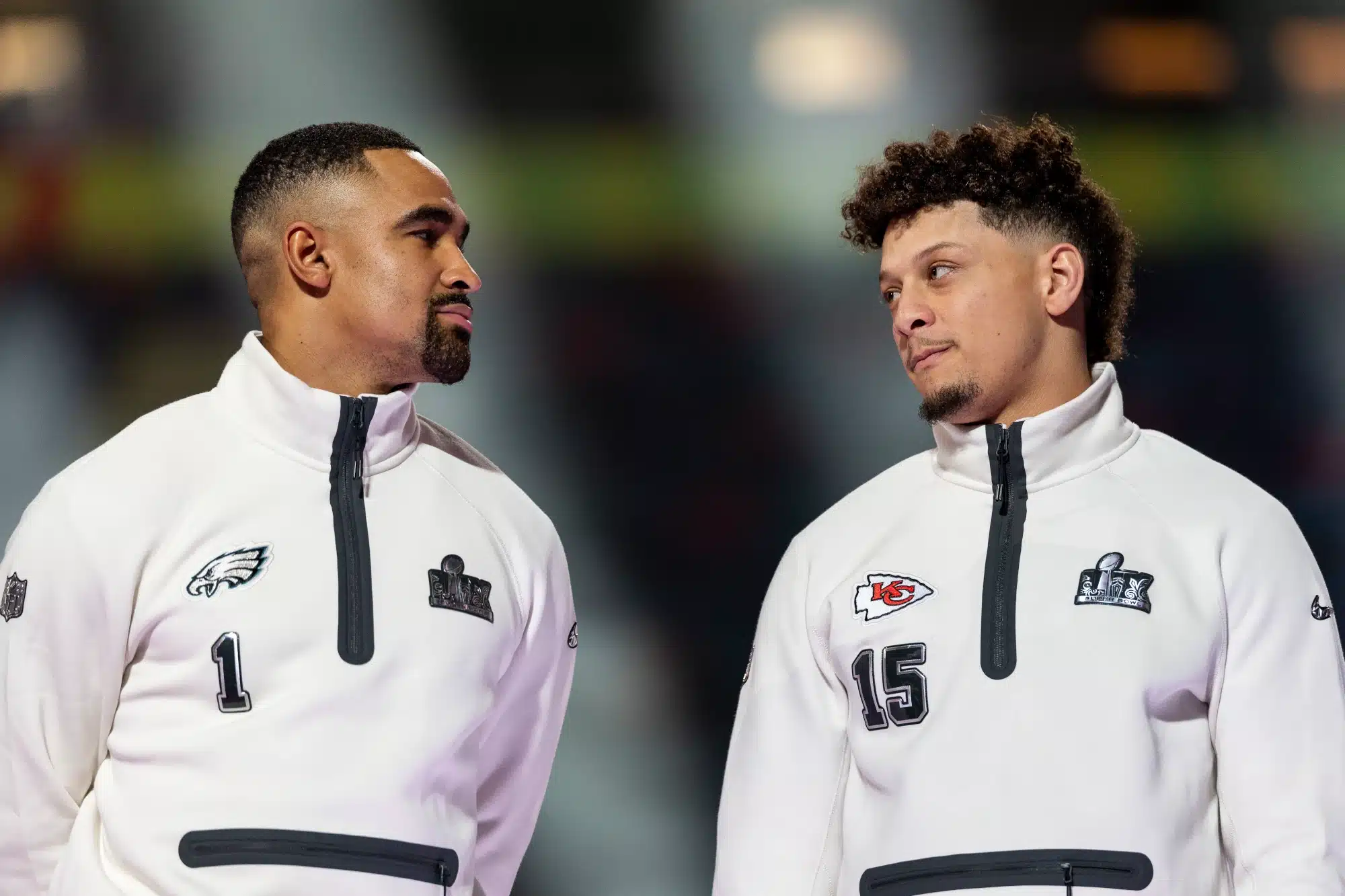 NEW ORLEANS, LOUISIANA - FEBRUARY 03: Jalen Hurts #1 of the Philadelphia Eagles and Patrick Mahomes #15 of the Kansas City Chiefs chat on stage during Super Bowl LIX Opening Night at Caesars Superdome on February 03, 2025 in New Orleans, Louisiana.