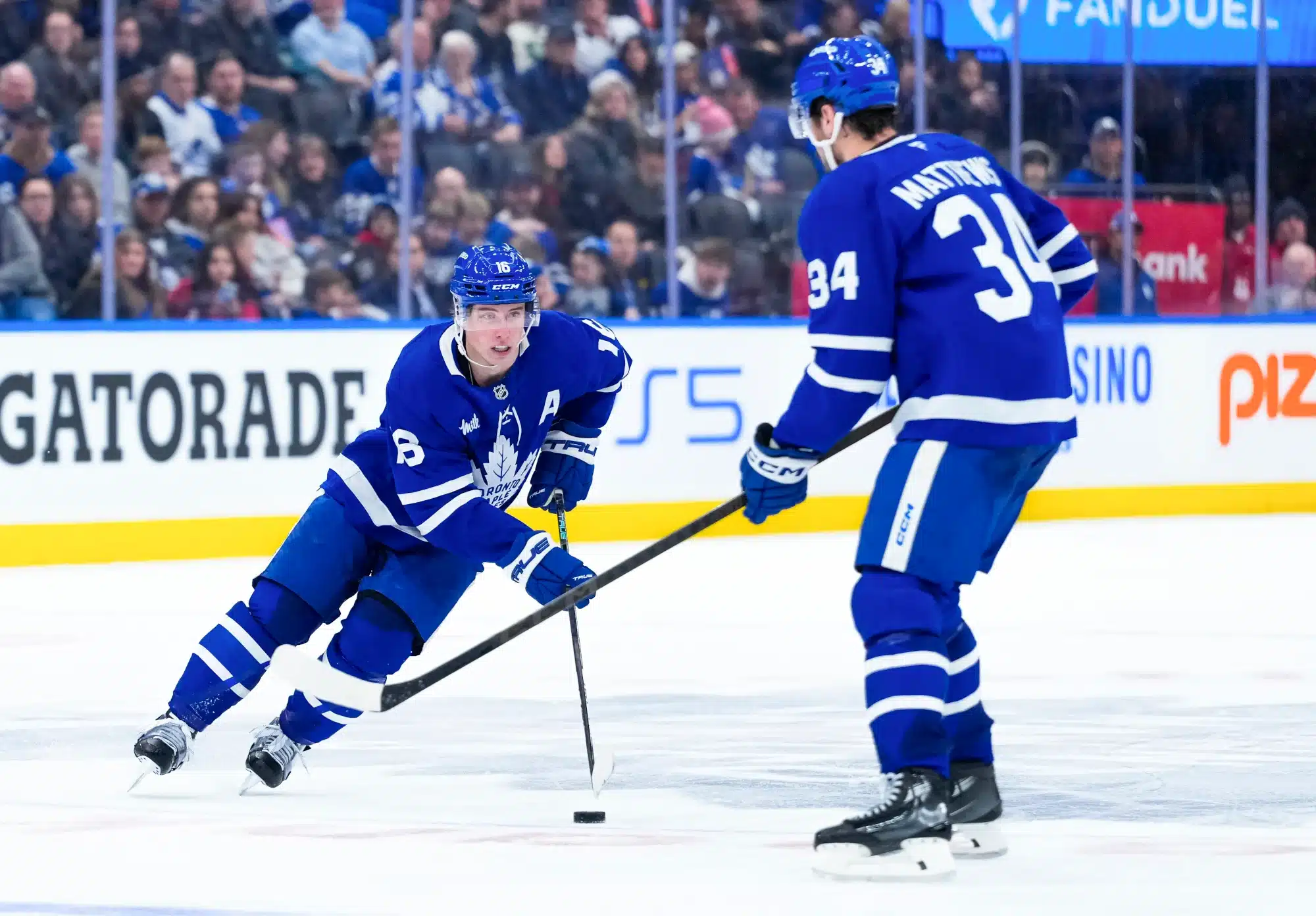 Mitch Marner #16 and Auston Matthews #34 of the Toronto Maple Leafs skates against the Carolina Hurricanes during the second period at the Scotiabank Arena on February 22, 2025 in Toronto, Ontario, Canada. 